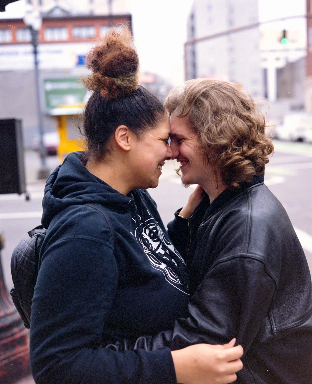 Couple sharing a kiss on a Portland street