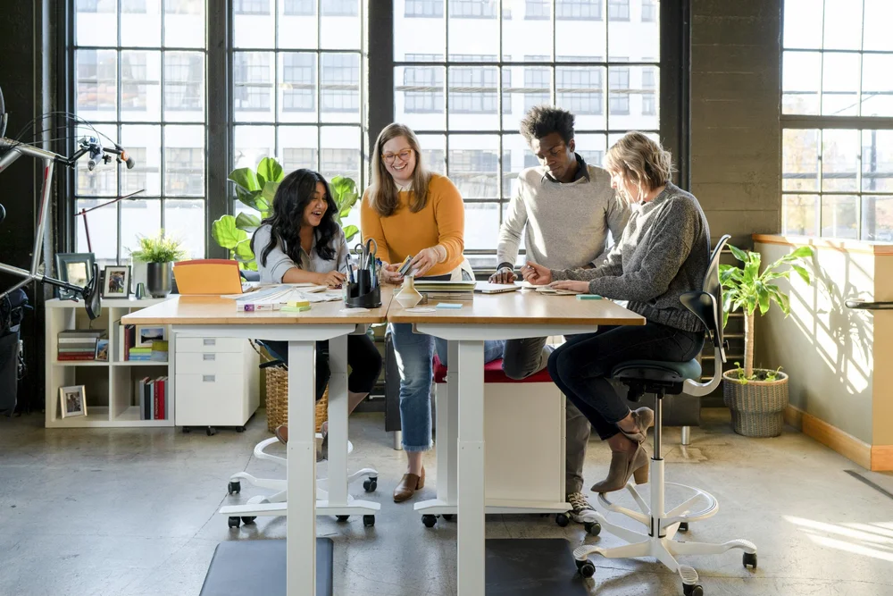 Team collaborating around a standing desk