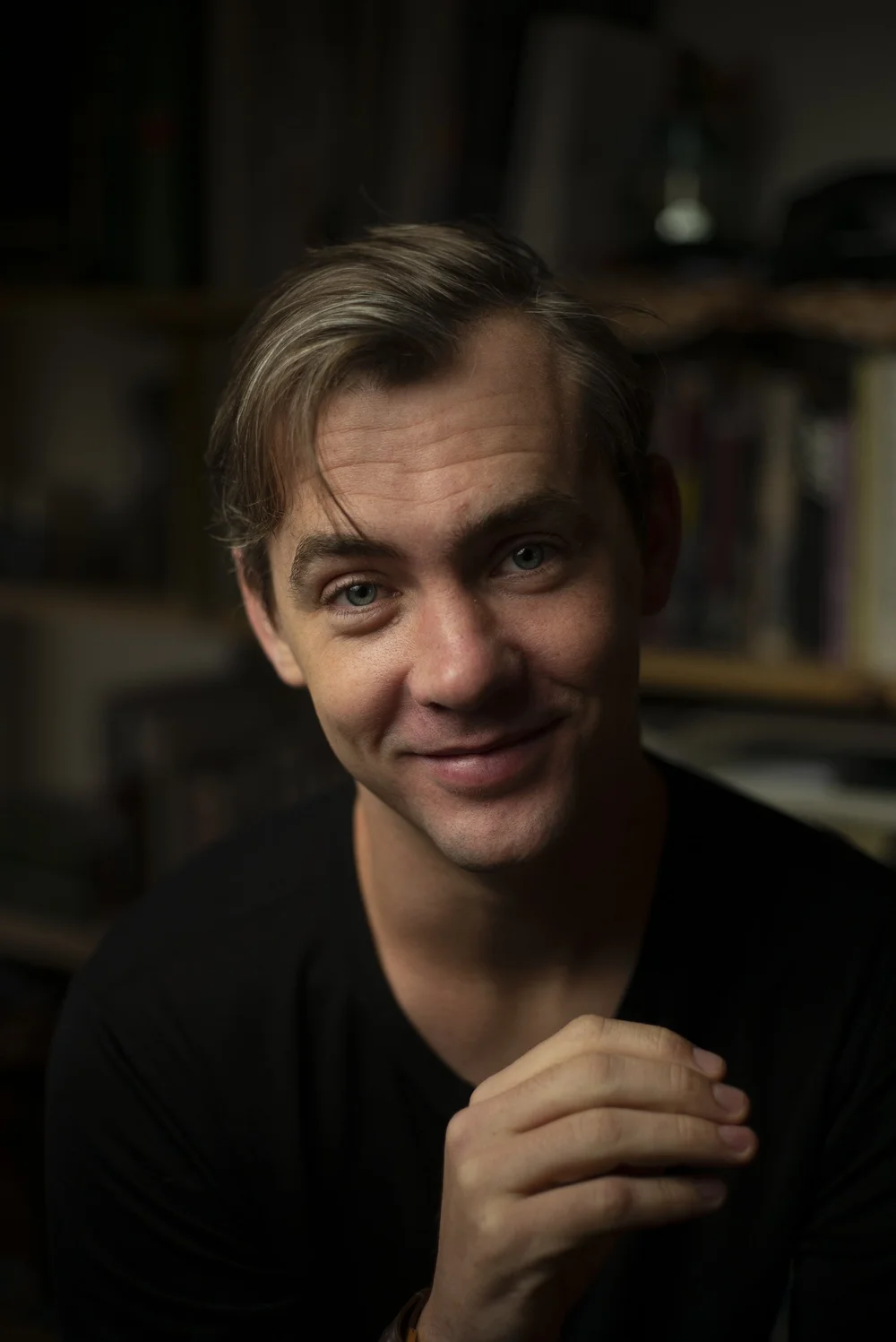 Man smiling in warm low light