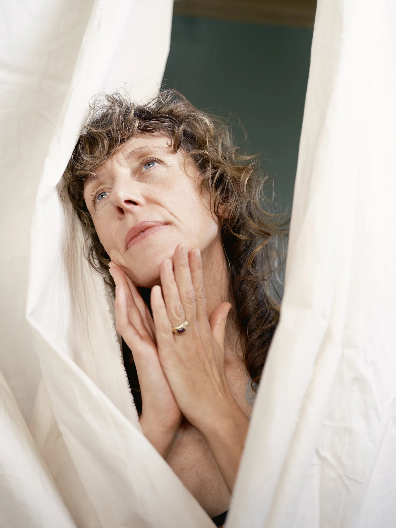 Quiet close portrait with a hand near the face