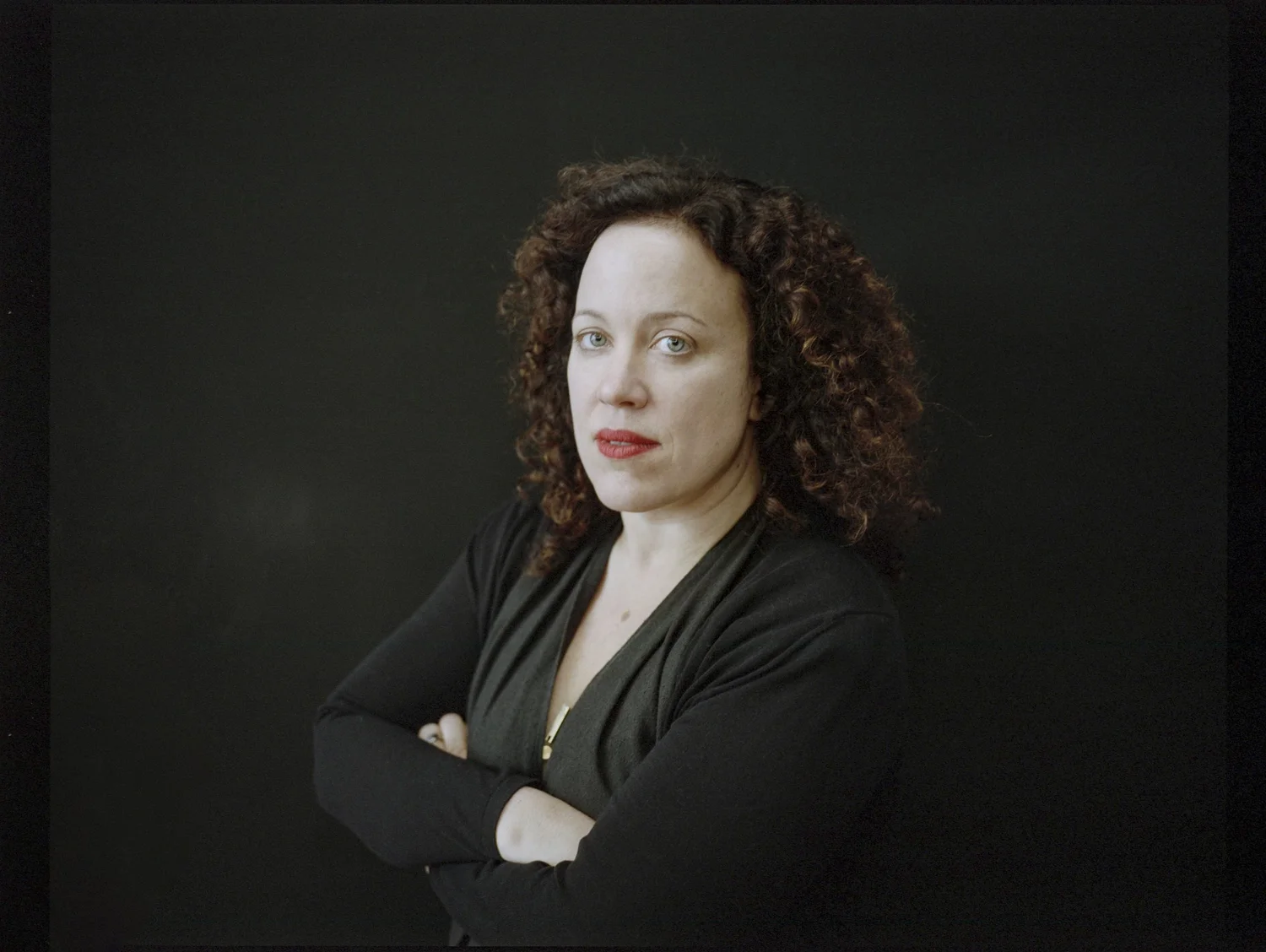 Formally dressed woman against a dark background
