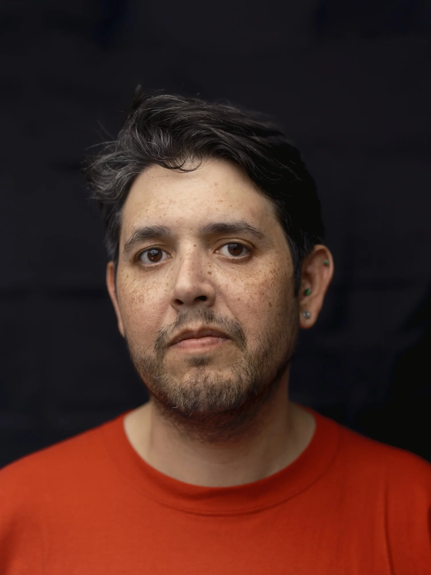 Professional portrait in an orange-red shirt