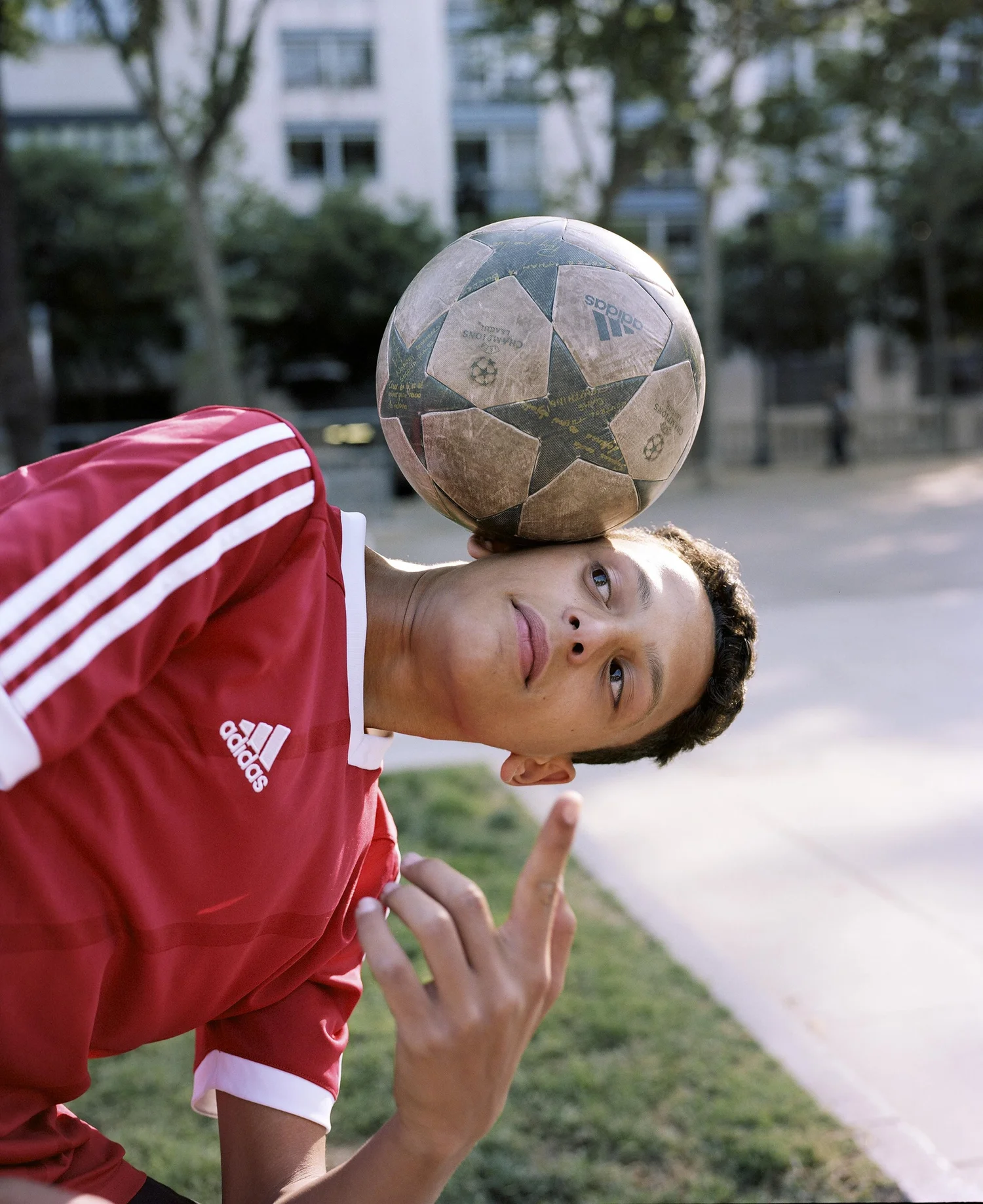 Footballer balancing a ball against their head