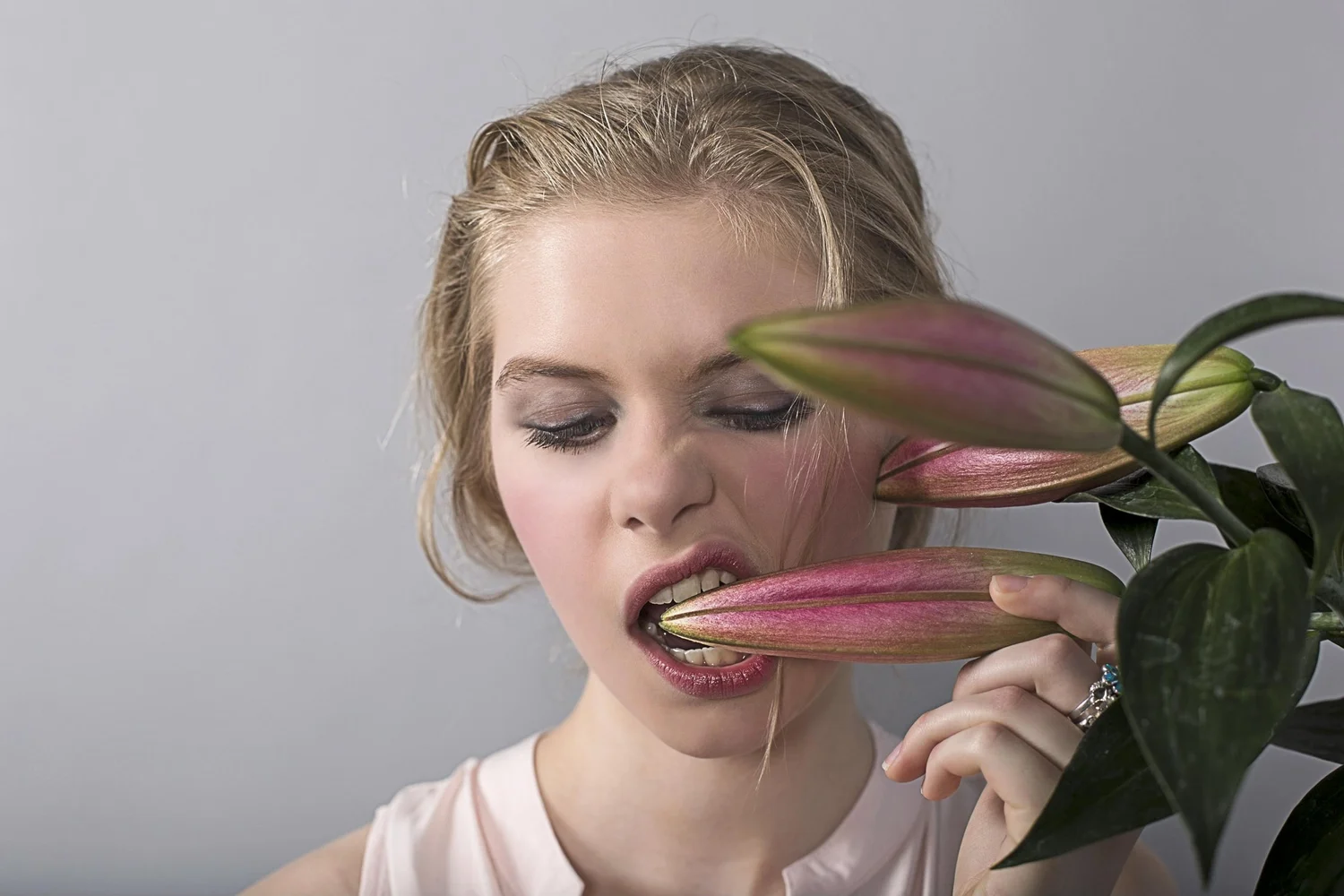 Profile portrait interacting with a large flower