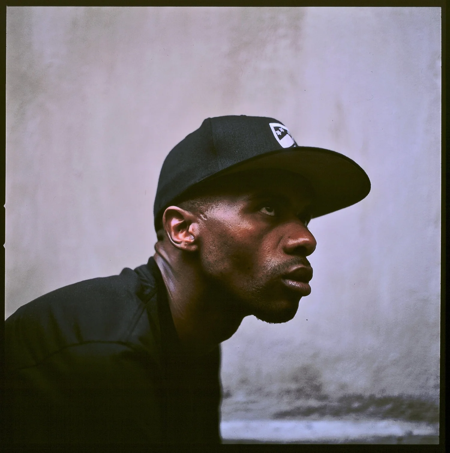 Side-profile music portrait in a cap