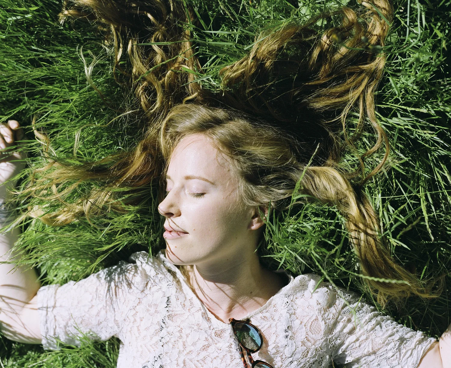 Woman resting among deep green foliage