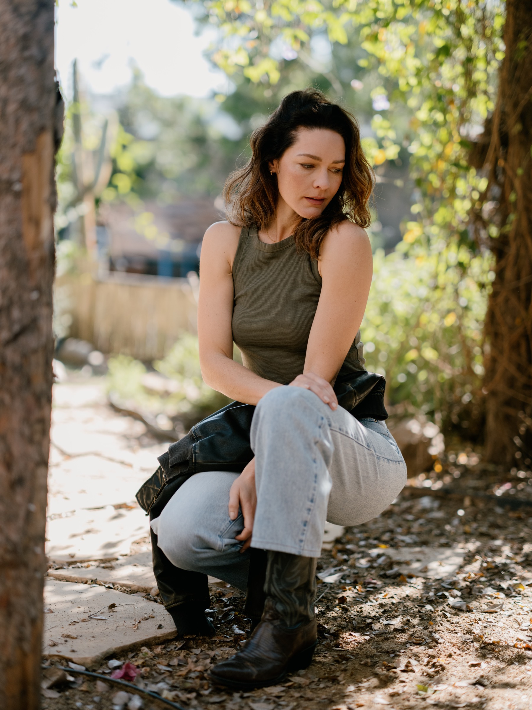 Outdoor environmental portrait of a seated woman