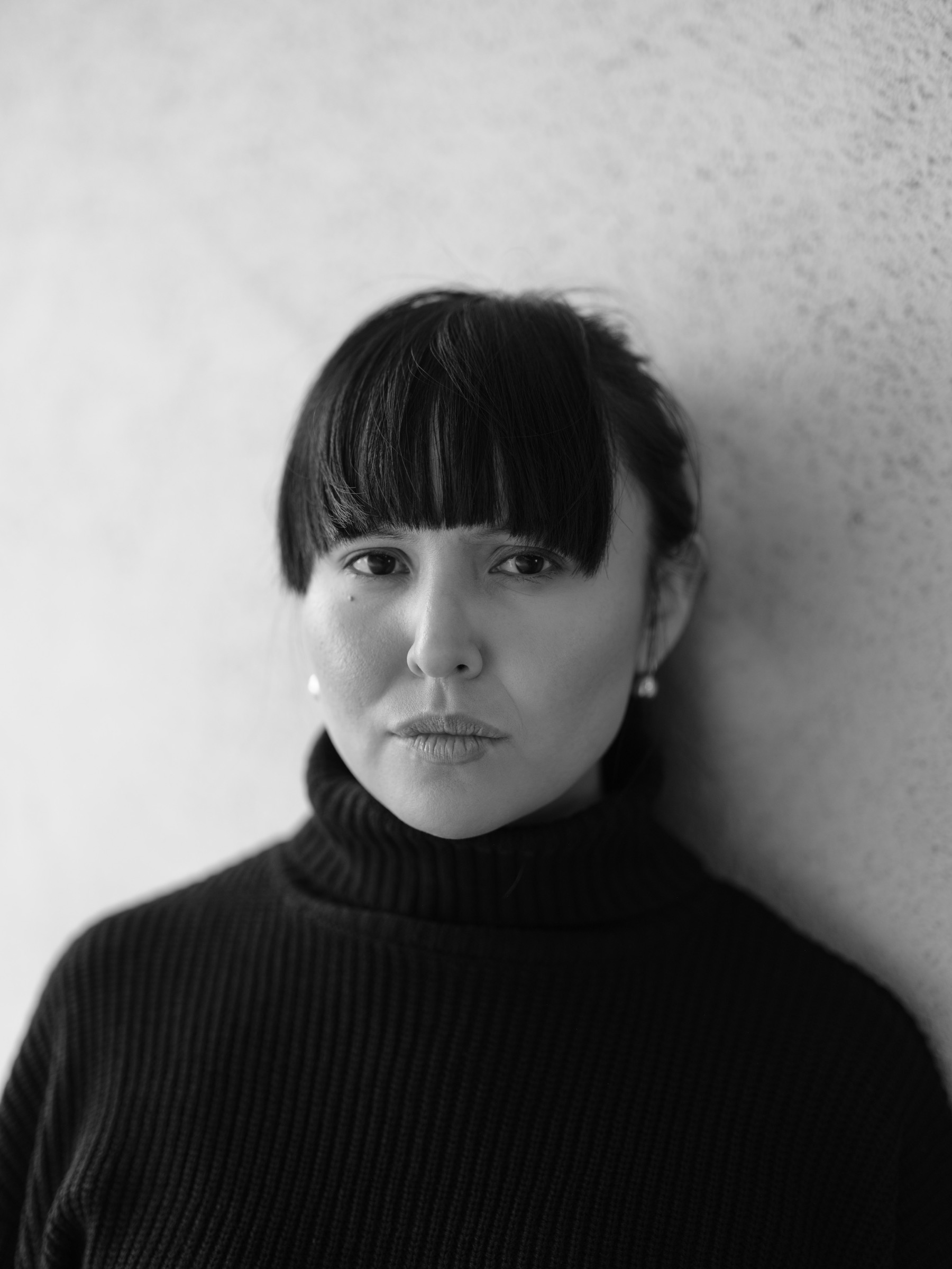 Black-and-white portrait of a woman in a dark turtleneck