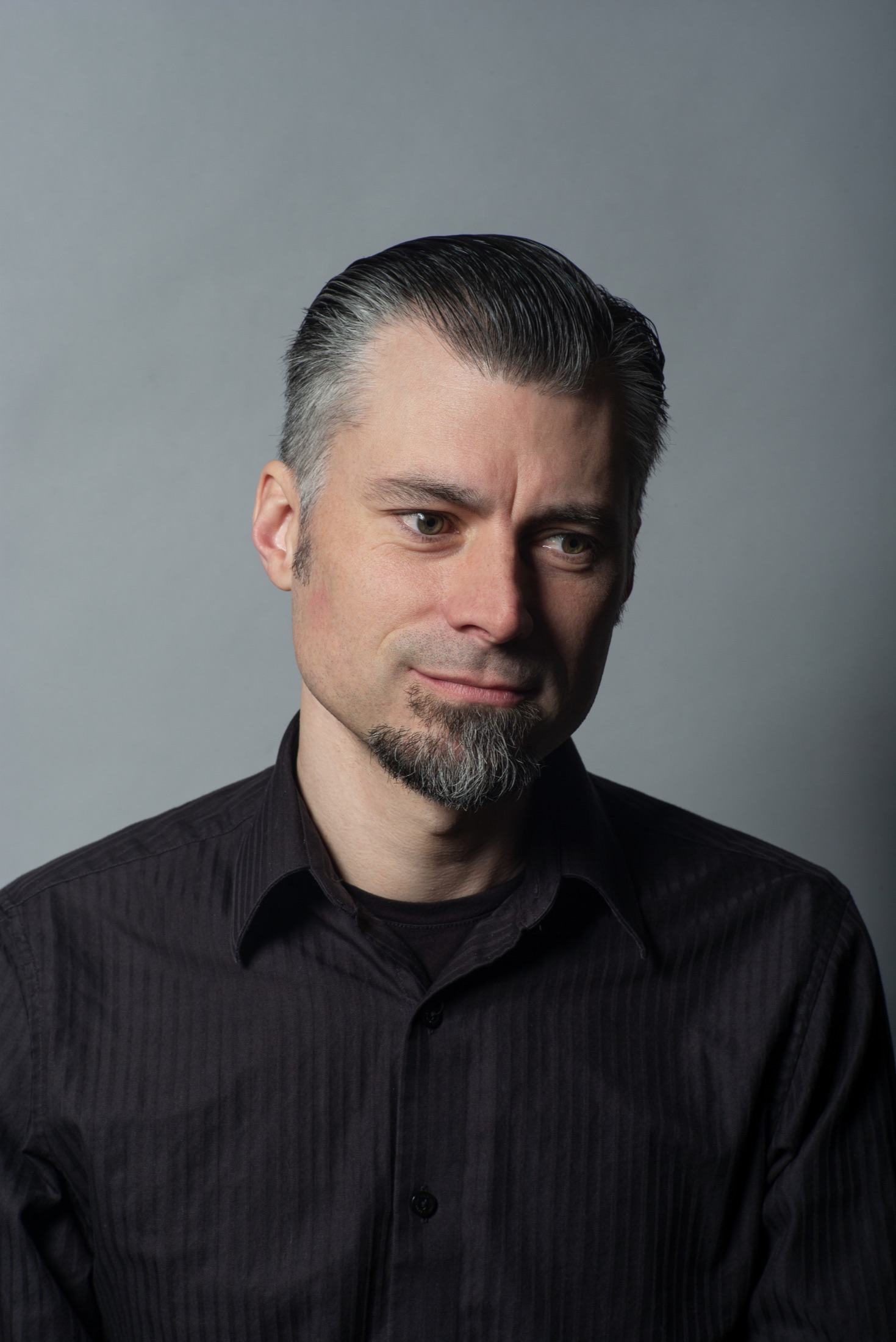 Professional studio portrait of a man with a goatee